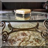 F59. Wrought metal table with beveled glass top.
